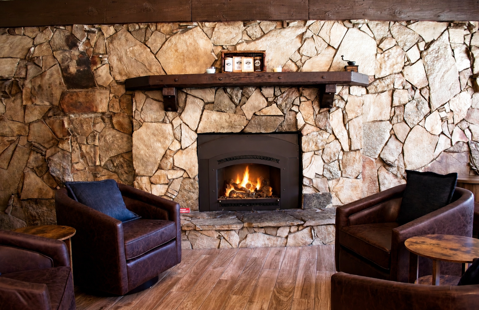 Warm mountain coffeehouse interior with stone fireplace
